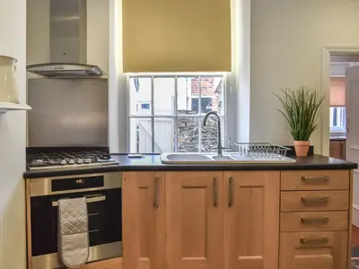 a kitchen with a sink and a stove at Ty Ni in Bala