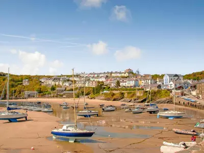 a group of boats sitting in the sand on a beach at Croft Y Beudy in Henfynyw Upper