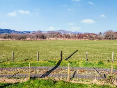 a fence in the middle of a field at Arthfan in Llanelltyd