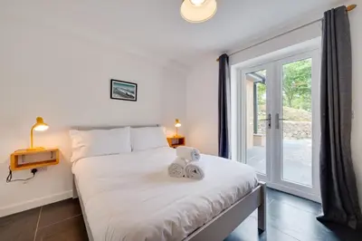 a bedroom with a bed and a large window at 3 Bed in Barmouth oc-wah701 in Barmouth