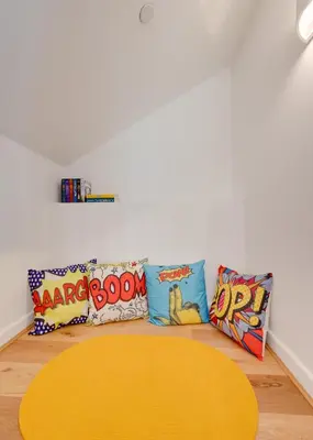 a living room with a yellow table and pillows at 3 Bed in Barmouth oc-wah701 in Barmouth