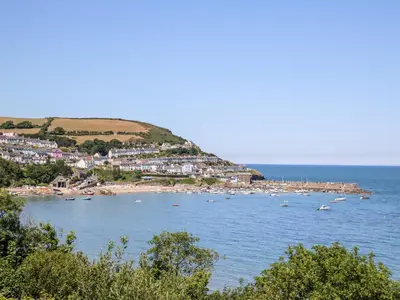 a view of a beach with boats in the water at Cwtsh Cragen in New Quay
