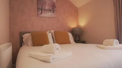 a bedroom with a bed with towels on it at Meadow Terrace in Shrewsbury