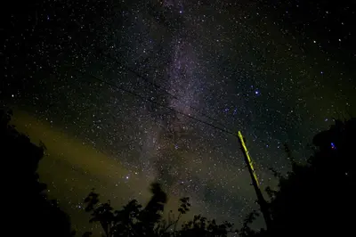 a starry night with a person on a power line at Romantic Croft with Private Hot Tub in Shrewsbury