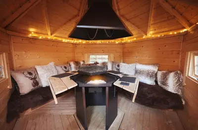a living room with a couch and a table in a cabin at Romantic Croft with Private Hot Tub in Shrewsbury