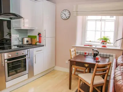 a kitchen with a table and a dining room at 138C Old Star and Garter Mews in Ludlow