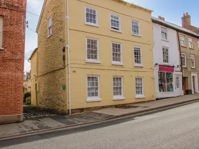 a yellow building on the side of a street at 138C Old Star and Garter Mews in Ludlow