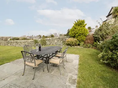 a table and chairs sitting on a patio at Ty Cerrig in Dyffryn