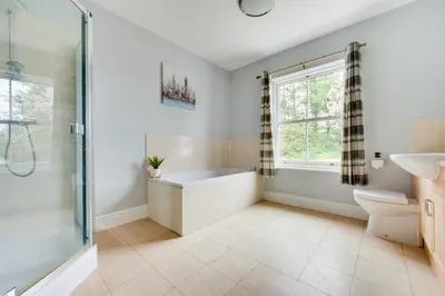 a bathroom with a tub and a toilet and a sink at 3 Bed in Bethlehem oc-waw219 in Llangadog