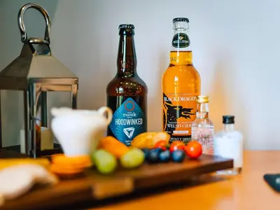 two bottles of beer sitting on top of a table at Cwtch Enrico - Uk39064 in Scyborycoed