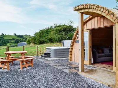 a wooden gazebo with a bench and a table at Mountain View - Uk34179 in Cilycwm