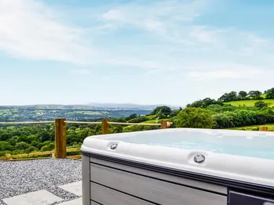 a jacuzzi tub on the patio of a house at Mountain View - Uk34179 in Cilycwm