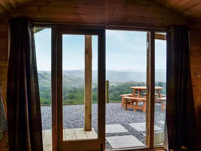 a glass door leading to a patio with a picnic table at Mountain View - Uk34179 in Cilycwm
