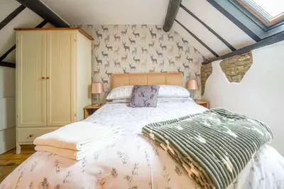 a bedroom with a large bed in a room at Cosy cottage in rural Culmington, Ludlow in Culmington