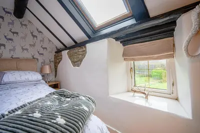 a bedroom with a bed and a window at Cosy cottage in rural Culmington, Ludlow in Culmington