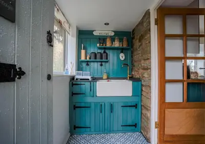 a kitchen with a blue cabinet and a sink at Cosy cottage in rural Culmington, Ludlow in Culmington