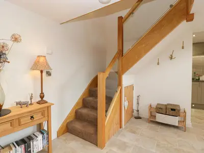 a staircase in a living room with a stair case at The Cart Barn in Leominster