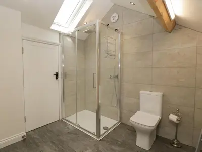 a bathroom with a shower and a toilet at The Cart Barn in Leominster