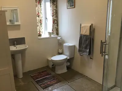 a bathroom with a toilet and a sink and a window at 1 Bed Lodge-Sleeps 4-Pet Friendly-Free Parking in Hereford