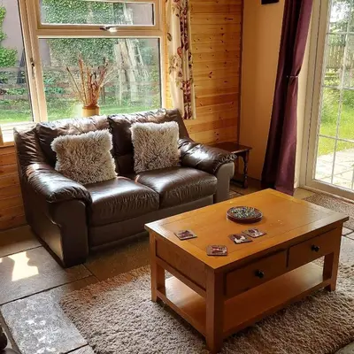 a living room with a leather couch and a coffee table at 1 Bed Lodge-Sleeps 4-Pet Friendly-Free Parking in Hereford