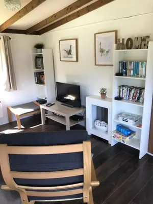 a living room with a desk and a chair at Pheasant Lodge in Builth Wells