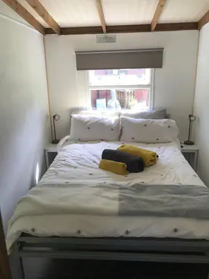 a bed in a room with two pillows and a window at Pheasant Lodge in Builth Wells