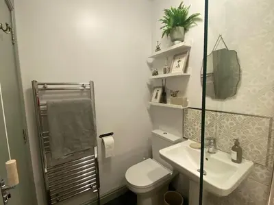 a white bathroom with a toilet and a sink at The Nest, central Ludlow one bed apartment in Ludlow