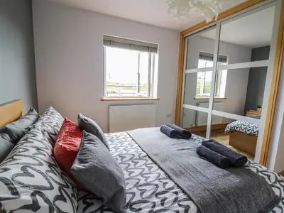 a bedroom with a bed with pillows on it at Llyn Cae Ty Nant Fishery Holiday Let in Lampeter