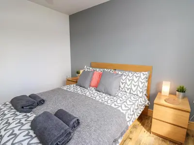 a bedroom with a bed with pillows on it at Llyn Cae Ty Nant Fishery Holiday Let in Lampeter
