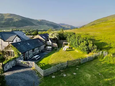 an aerial view of a house with a yard at Romantic Snowdonia Cottage with Hot tub, sea & mountain views in Tywyn