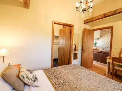 a bedroom with a bed and a living room at Golwg Las in Llanwrda