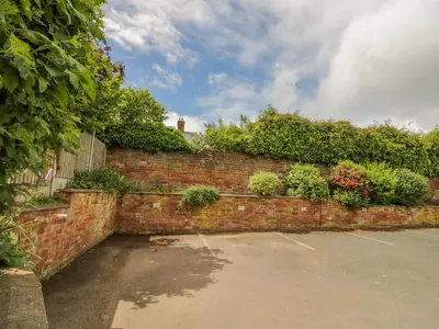 a brick wall with plants on top of it at 2 The Villa in Ludlow
