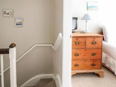 a bedroom with a bed and a dresser with a television at Artro View in Llanbedr