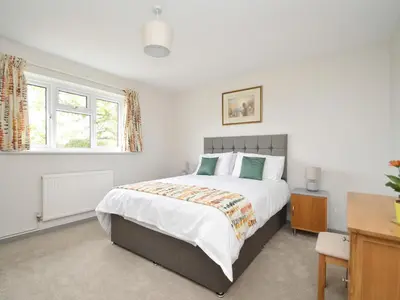 a bedroom with a large bed and a desk at Berwyn View in Welshpool