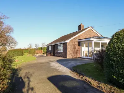 a brick house with a driveway in front of it at Berwyn View in Welshpool