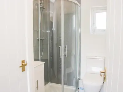 a bathroom with a shower and a toilet at Little Oakleigh in Llanymynech