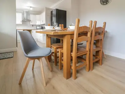 a kitchen with a wooden table and chairs at Bryn Teg in Oswestry