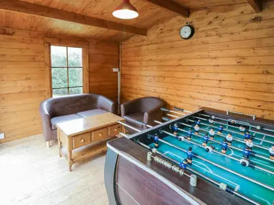 a living room with a pool table in a cabin at Bryn Teg in Oswestry