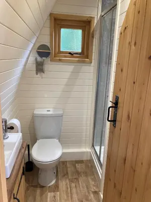a small bathroom with a toilet and a sink at Delor - Bryntalch Glamping Pods in Montgomery