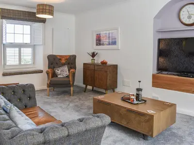 a living room with a couch and a coffee table at Bryn Y Felin in Dyffryn