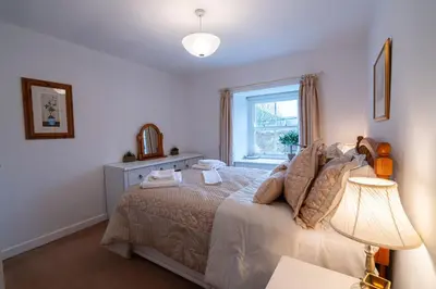 a bedroom with a bed and a window at Ty Canol Maentwrog, Snowdonia Nr Zip World in Maentwrog