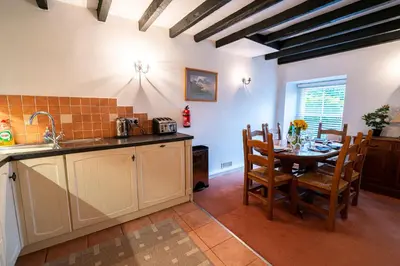 a kitchen and dining room with a table and chairs at Ty Canol Maentwrog, Snowdonia Nr Zip World in Maentwrog
