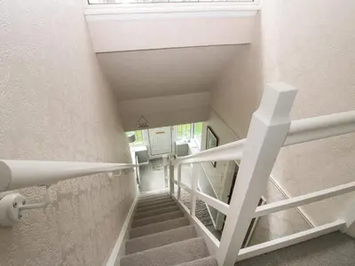 a staircase in a room with a white stair case at Roseland in Ludlow