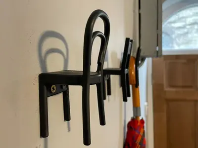 a group of black chairs hanging on a wall at The Bala House in Bala