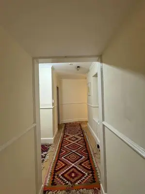 an empty hallway with a rug on the floor at Cae Nest Hall in Llanbedr