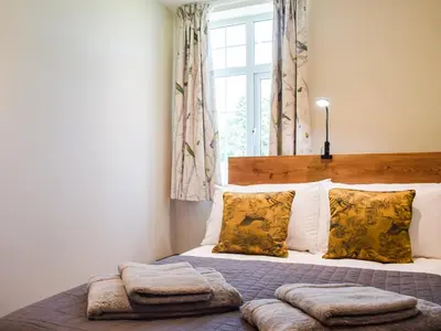 a bedroom with a bed with pillows and a window at Barnleigh in Ludlow