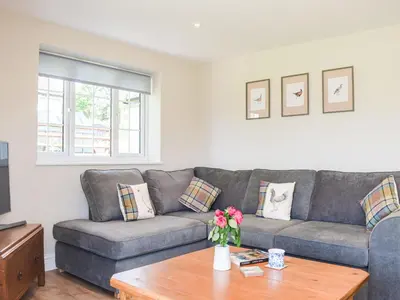 a living room with a couch and a table at Barnleigh in Ludlow
