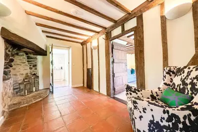 a living room with a couch and a stone fireplace at Marrington Mill in Chirbury