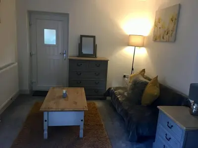 a living room with a couch and a coffee table at Daffodil House , West Wales in Llandovery