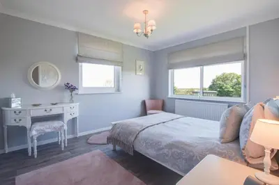 a bedroom with a bed and a desk and window at 3 Bed in Aberaeron oc-bow330 in Ciliau-Aeron